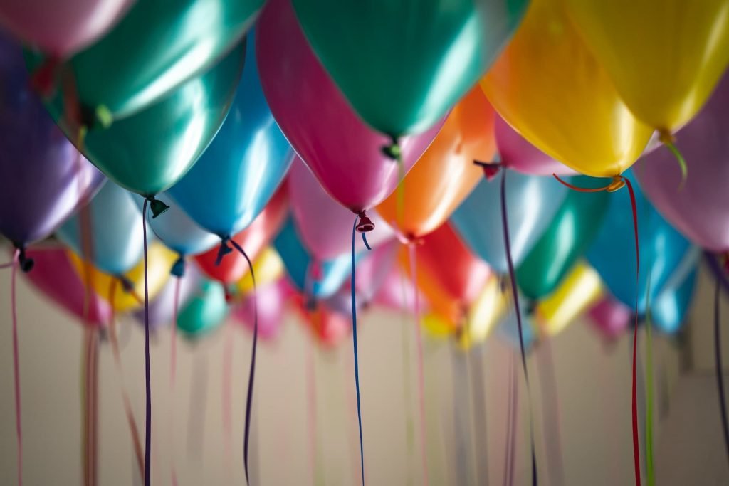 many balloons floating during a birthday party